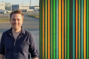 Tom Tiner, Editor in Chief at MV Pro Media poses in front of factory gate